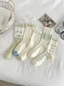 Set of 5 aesthetic light green and cream long socks with floral and stripe patterns.