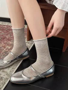 Detailaufnahme von atmungsaktiven Hohlnetzsocken kombiniert mit stylischen silbernen Schuhen.