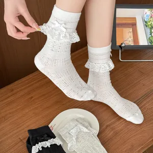Detailed view of sweet JK style lace ruffle mesh mid-tube socks with cute bows for summer.