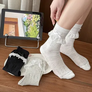 Close-up detail of sweet JK lace mesh mid-tube socks with cute bow, soft and breathable.