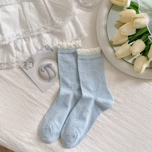 Sweet women's light blue crew socks with lace ruffle cuffs and cute bow patterns for summer.