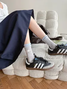 Detailansicht gerippter Socken mit farbabgesetzten Doppelbündchen und kleinem Label.