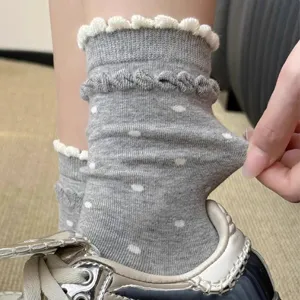 Grey cute polka dot mid-tube socks with white lace and stretch fabric detail showcase.