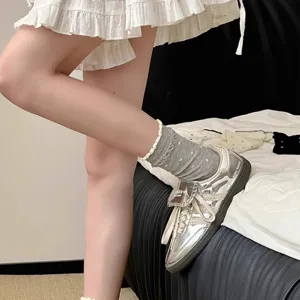 Detail view of cute white lace ruffle mid-calf socks for women, Japanese retro college style.