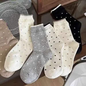 Cute Japanese vintage polka dot mid-calf socks with delicate lace ruffle trim for women.