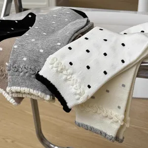 Cute Japanese vintage polka dot women mid-tube socks with delicate lace ruffle cuffs.