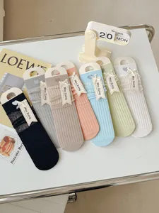 Detailed view of breathable mesh mid-calf women socks with sweet heart embroidery and cute bow tags.