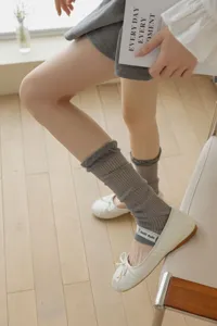 Detailed view of sheer summer women stacking socks paired with trendy ballet flats.