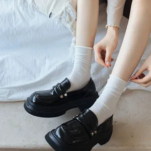 Women white slouch socks cozy mid-calf cotton socks paired with black loafers stylish everyday look.