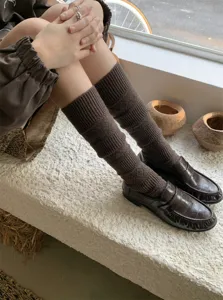 Cozy brown knit leg warmers with diamond hollow pattern, stylish autumn winter knee-high socks.