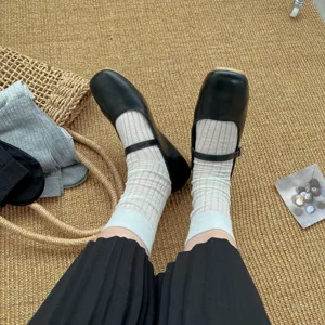Japanese style white ribbed mid-calf socks nicely paired with black Mary Jane shoes.