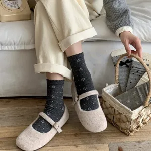 Cozy grey floral mid-calf socks paired with soft fuzzy shoes, perfect for daily casual wear.