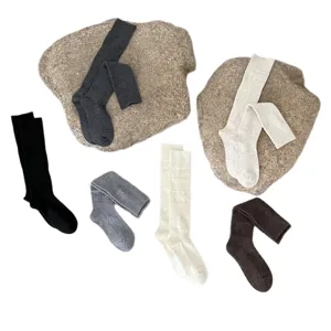 Warm knit over-the-knee socks for women, thick wool long stockings with diamond hollow pattern.