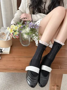 Sweet black lace bow mid-calf socks for women, breathable mesh design, stylish cute hosiery.