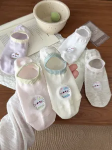 Detail view of cute Japanese style bow boat socks for women, breathable cotton low cut design.