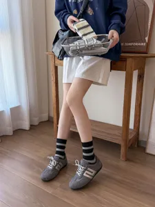 Koreanische gestreifte Wadenstrümpfe kombiniert mit Retro Freizeitschuhen für Damen.