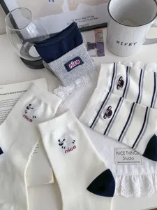 Detailed view of women's cute cartoon cotton mid-calf socks with stripe and animal patterns.