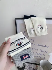 Detailed view of women's autumn winter combed cotton mid-tube socks with cute sheep embroidery.