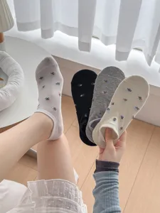 Detail view of cute floral boat socks in assorted colors showcasing soft breathable cotton material.