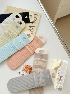 Close-up detail view of cute mesh stackable socks with heart embroidery, sweet style.