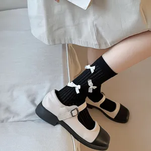 Sweet bow mid-calf socks paired with classic Mary Jane shoes, perfect for cute daily wear.