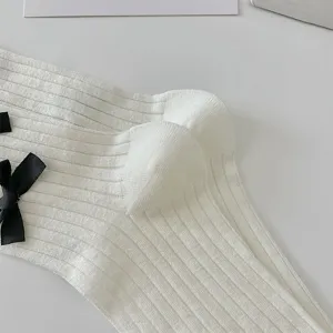 Close-up of sweet bow mid-tube thin socks, solid color basic design for versatile daily wear.