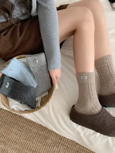 Cozy autumn and winter women knit mid-tube socks with cute letter label, soft daily wear.