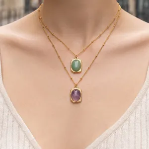 Collier double couche en acier inoxydable plaque or 18k avec pendentifs en pierre ovale.