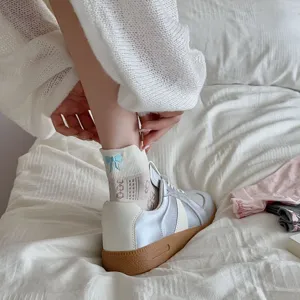 Cute Japanese style cotton low-cut boat socks with blue bow embroidery and breathable design.