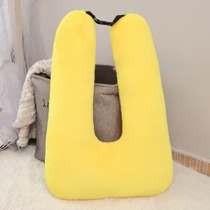 Yellow plush U-shaped car pillow with adjustable strap, soft neck cushion for travel and nap.