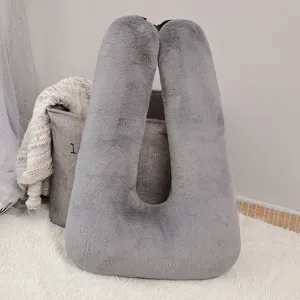 Grey plush U-shaped pillow, soft multi-functional neck cushion for car travel and sleeping.