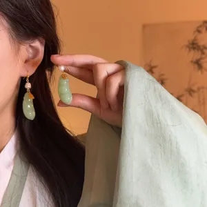 Traditional Chinese style green jade bean pearl drop earrings detail shot, elegant vintage jewelry.