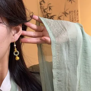 Traditional Chinese style handmade gold-plated pearl jade ring bell tassel earrings detail shot