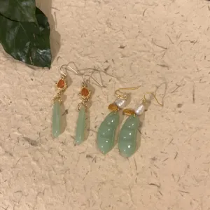 Detailed view of Chinese style handmade jade and pearl earrings with gemstone charms.