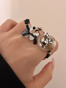 Y2K beaded flower and teapot ring detail shot, unique handmade stackable fashion jewelry.