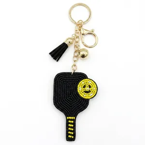 Perlen Pickleball Schlüsselanhänger mit schwarzer Quaste und goldener Hardware für Taschen.