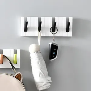 Wall mounted key and coat hook, 4-hook piano style organizer for home hallway and doorway storage.