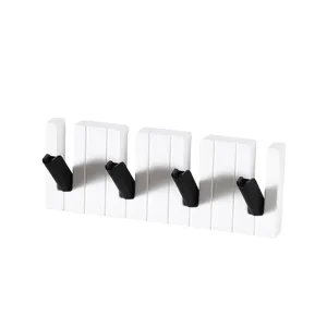 Modern piano wall coat hook with four foldable hooks, nail-free wall mounted rack for home.