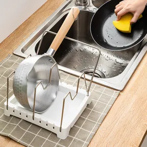 Adjustable kitchen cookware storage rack with stainless steel brackets and white base for pots.