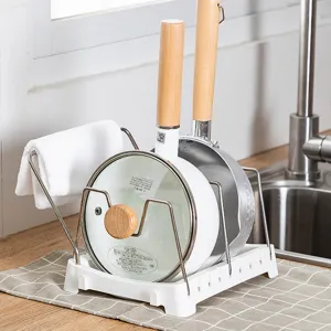 Adjustable kitchen pan and lid organizer rack with towel holder and stainless steel stands.