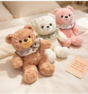 Detail of cute plush teddy bears with lace bibs, featuring soft textured fur in cozy bedroom.