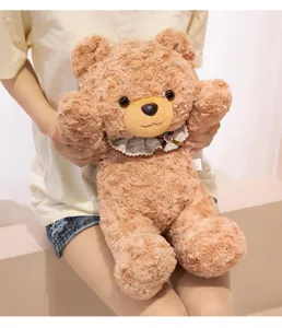 Cute brown teddy bear plush toy with stylish bib collar, soft stuffed doll for girls.