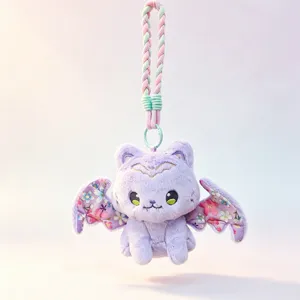 Detailed close-up of the cute plush bat cat keychain, featuring floral wings and braided strap.