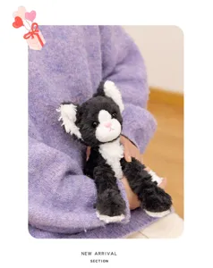 Black and white cat plush toy detail, soft stuffed animal kitten doll for kids companionship.