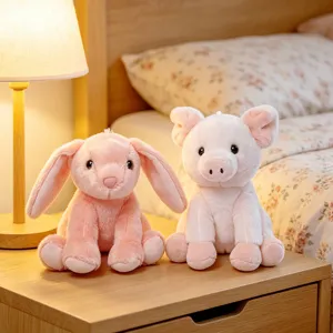 Cute pink bunny and pig plush toys sitting together on a bedside table, soft comforting doll.