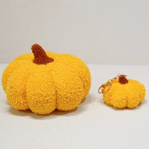 Cute plush pumpkin pillow and matching keychain set, soft stuffed toy for autumn decor.