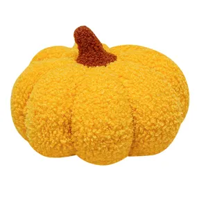 Cute yellow plush pumpkin pillow, soft stuffed toy for autumn home decor and children gift.