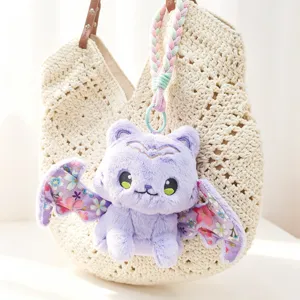 Cute purple plush bat cat keychain charm detail, featuring soft floral wing design and braid.