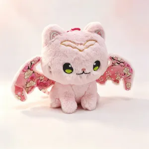 Detailed view of the cute pink bat cat plush toy keychain with soft fur and cherry blossom wings.