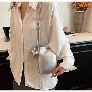 Silver mini phone bag with elephant charm and metallic chain crossbody strap for women.